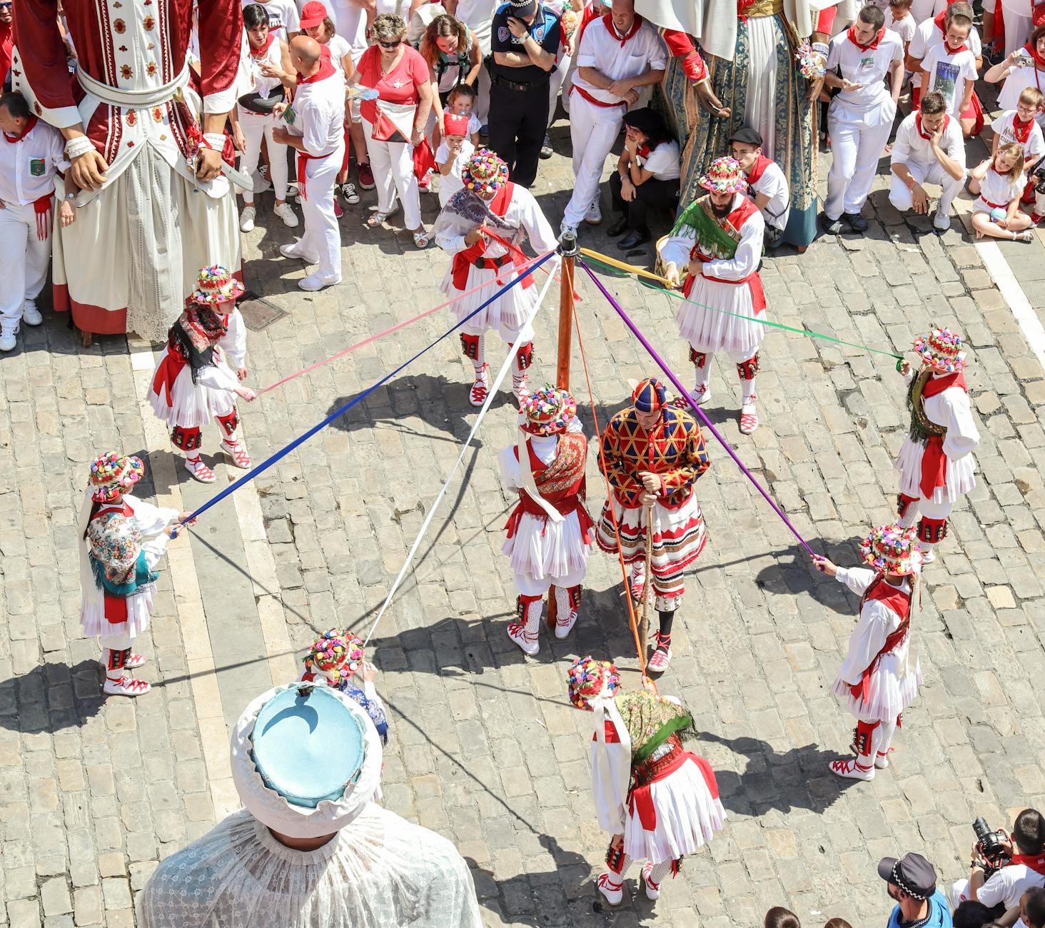 Colorful traditional dance with costumed performers at an outdoor festival.