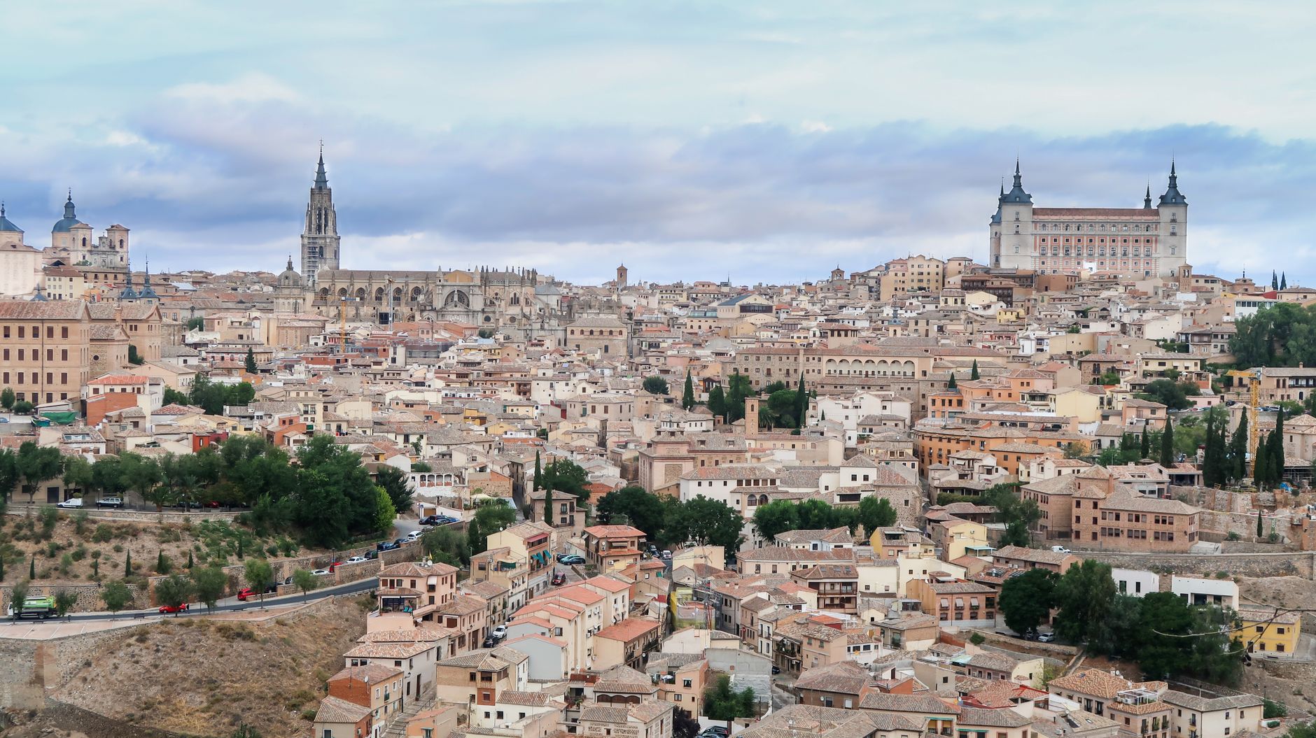 A captivating aerial view of the historic cityscape of Toledo, Spain featuring the Alcazar and stunning architecture.