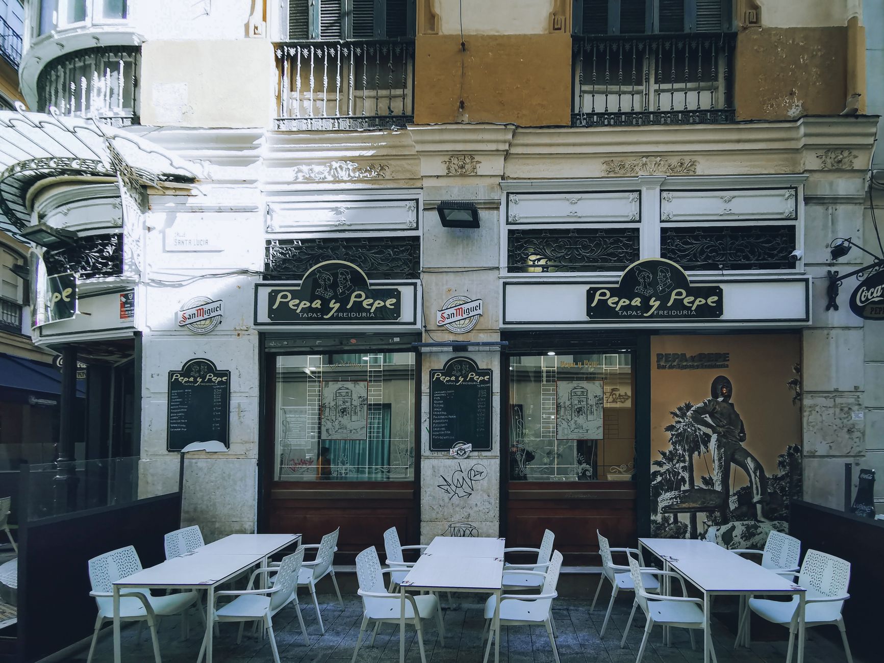 Quaint outdoor dining area at &lsquo;Pepa y Pepe&rsquo; tapas bar in urban setting.