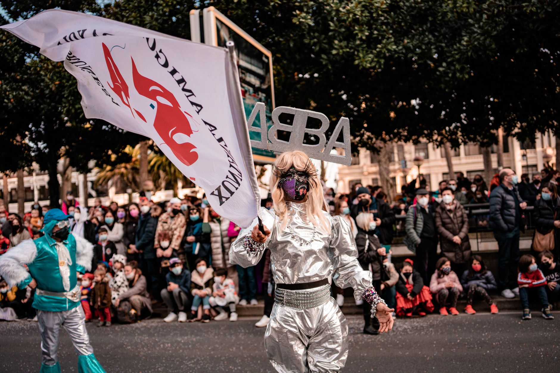 Colorful costumes and vibrant atmosphere during a street parade in A Coruña, Spain.