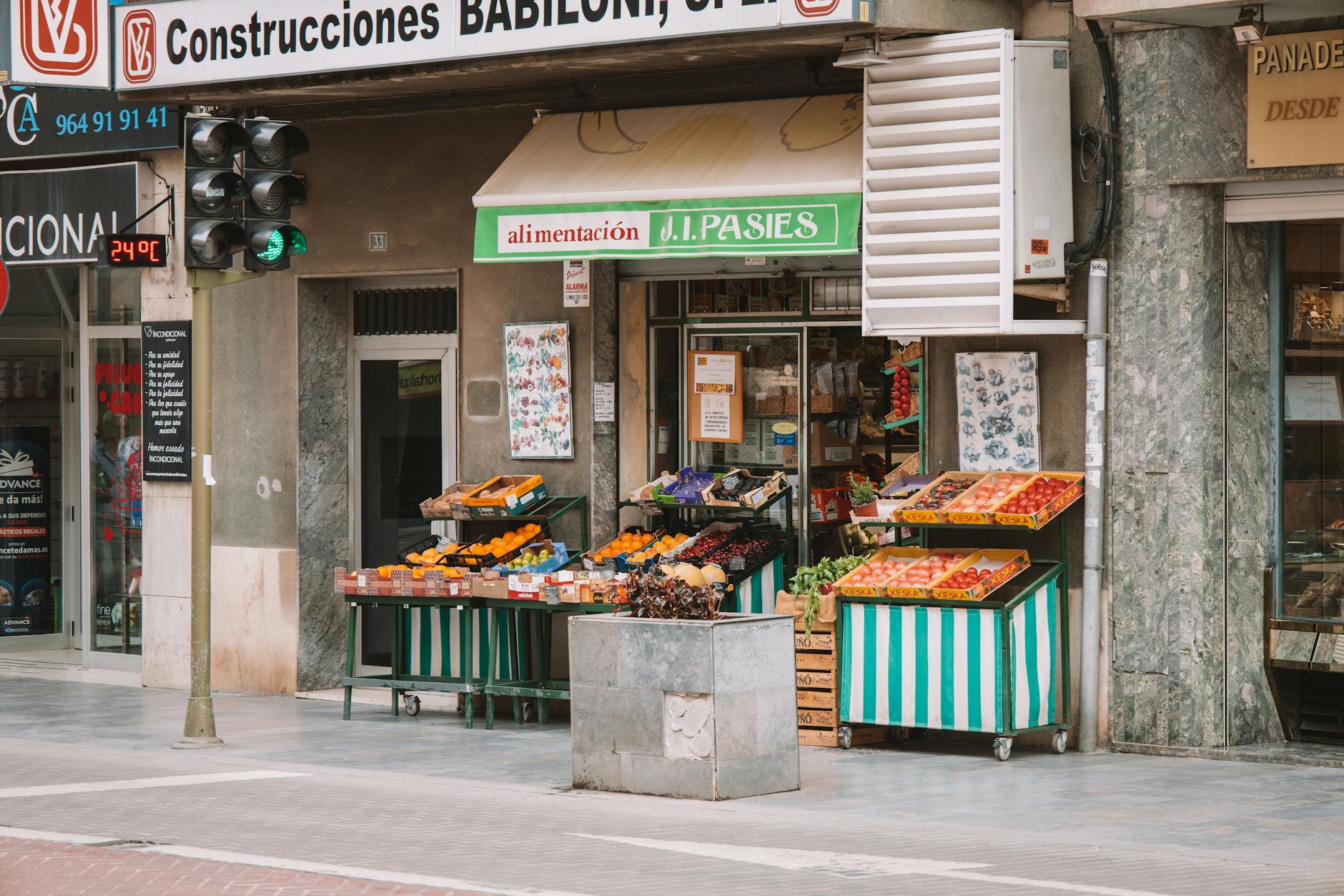 Colorful street market in Valencia, Spain, featuring vibrant fruits and vegetables.