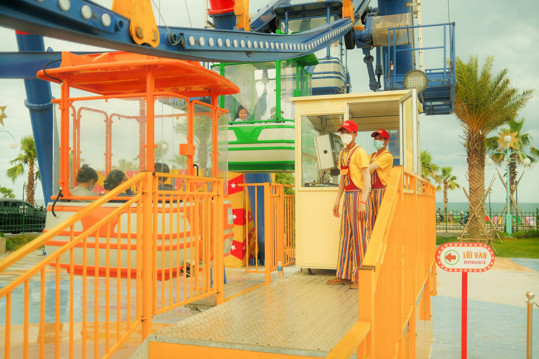 Vibrant outdoor fairground scene with attendants and riders enjoying the amusement ride.