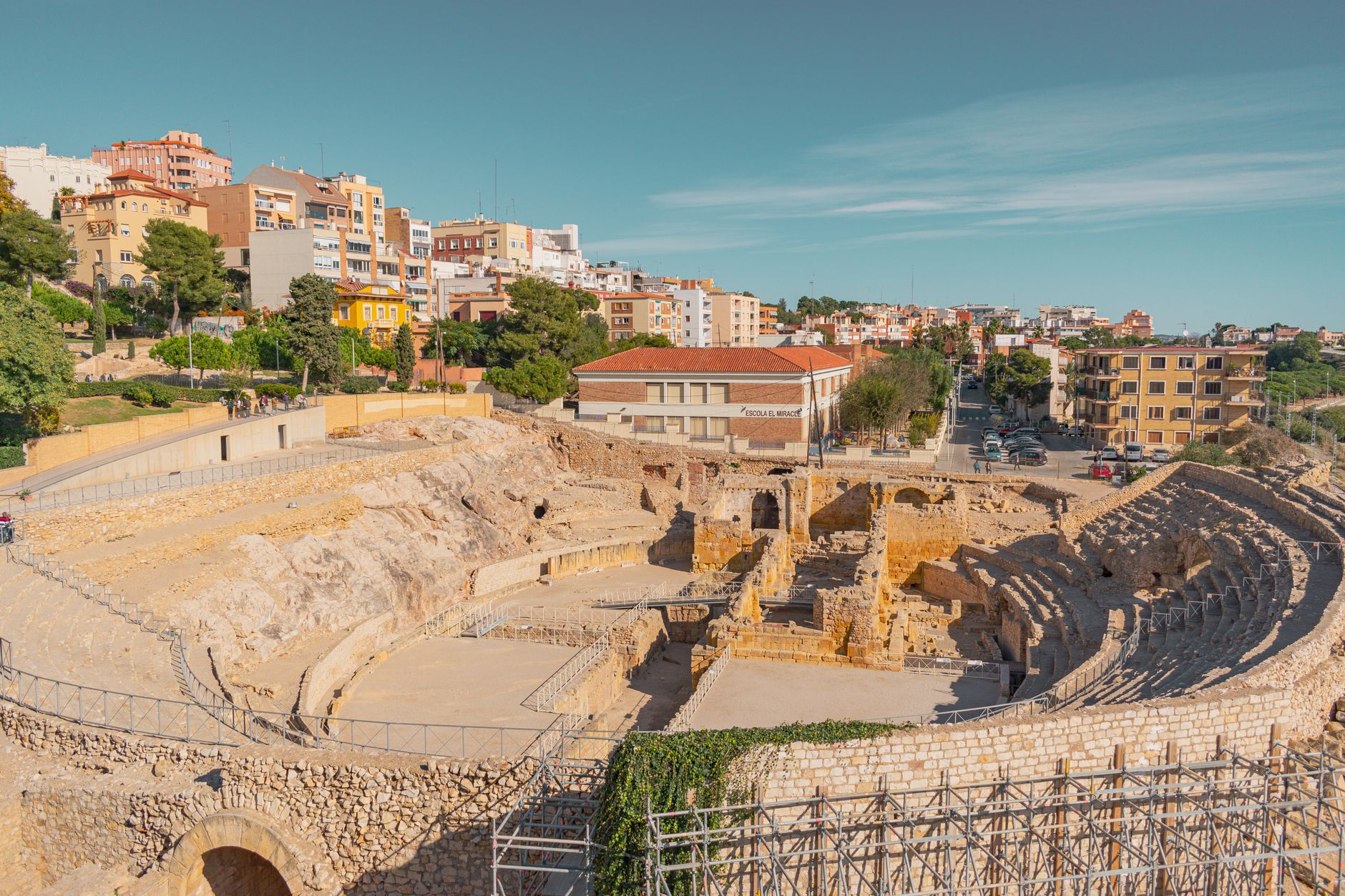 Discover the ancient Roman Amphitheatre in Tarragona under a clear blue sky.