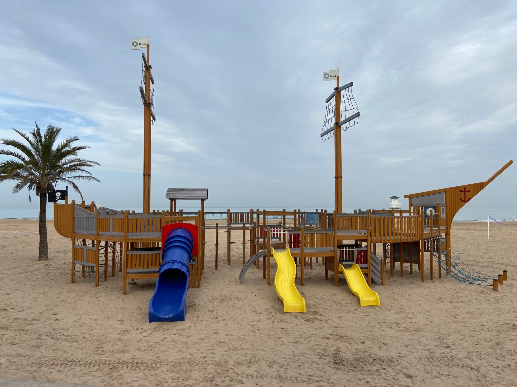Vibrant pirate ship playground on Playa de Gandía beach, Spain.