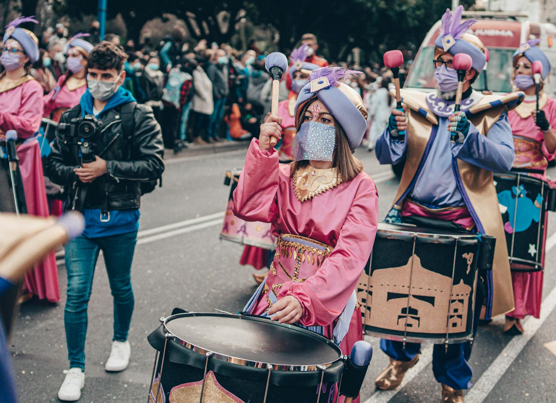 Vibrant street parade with costumed drummers in A Coruña, Spain.