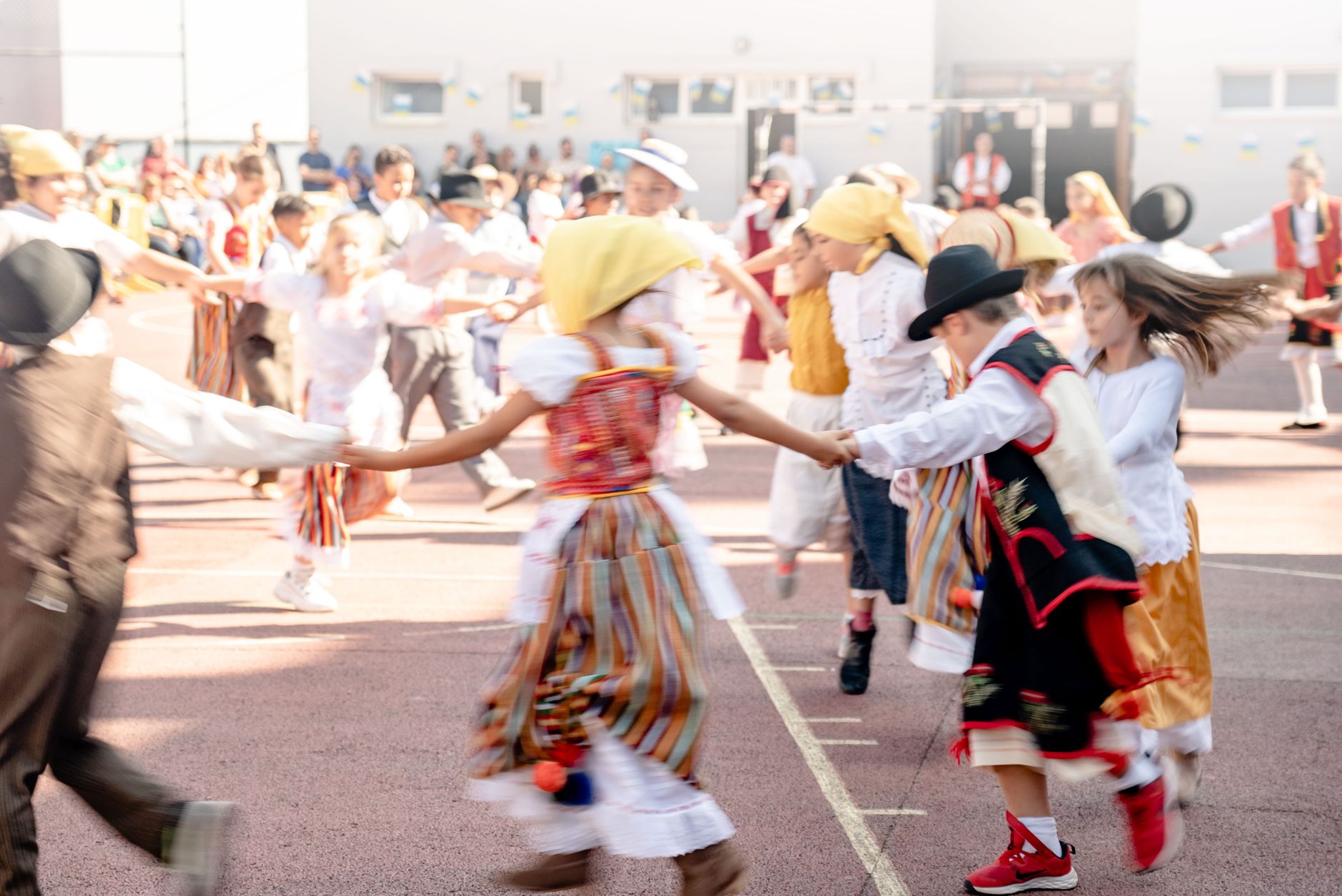 Children in traditional costumes dancing outdoors at a cultural festival in La Orotava, Spain.