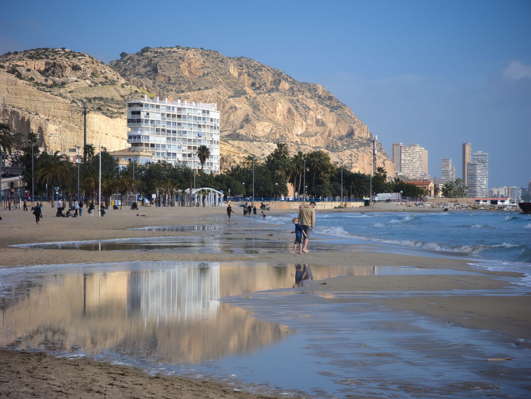 Explore the serene beach of Alicante with its stunning coastal reflections and vibrant atmosphere.